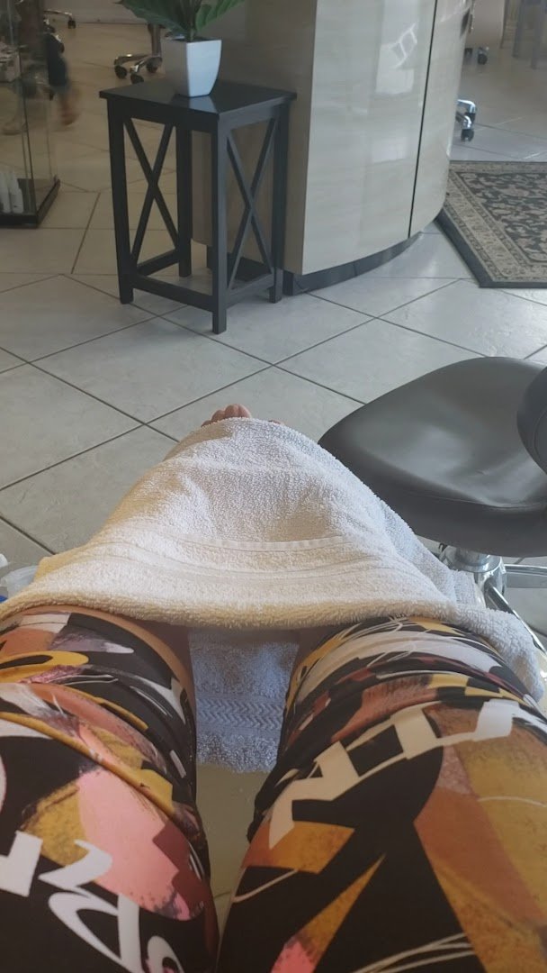 Pedicure chair beside a tidy nail station.